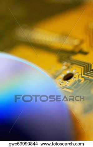 Picture - Close-up of a CD on a circuit board. Fotosearch