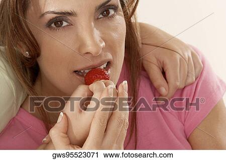 Close-up of a daughter feeding her mother a strawberry View Large Photo Image Stock Image - Close-up of a daughter feeding her mother a strawberry. Fotosearch