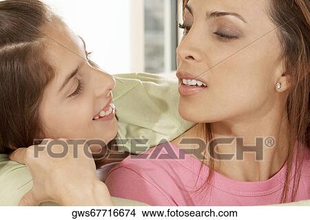 Close-up of a daughter hugging her mother View Large Photo Image Picture - Close-up of a daughter hugging her mother. Fotosearch