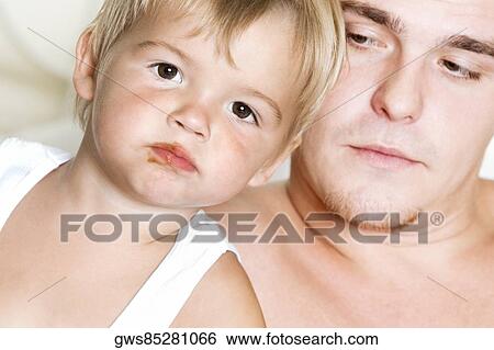 Close-up of a father and his son View Large Photo Image Stock Photograph - Close-up of a father and his son. Fotosearch