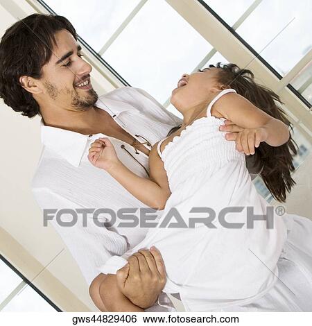 Close-up of a father carrying his daughter View Large Photo Image Stock Photograph - Close-up of a father carrying his daughter. Fotosearch