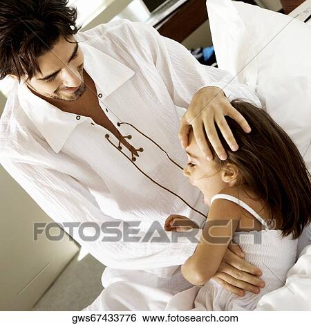 Close-up of a father playing with his daughter View Large Photo Image Stock Photograph - Close-up of a father playing with his daughter. Fotosearch