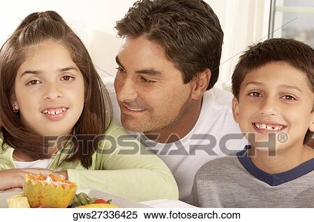 Close-up of a father with his son and his daughter smiling View Large Photo Image Stock Photography - Close-up of a father with his son and his daughter smiling. Fotosearch
