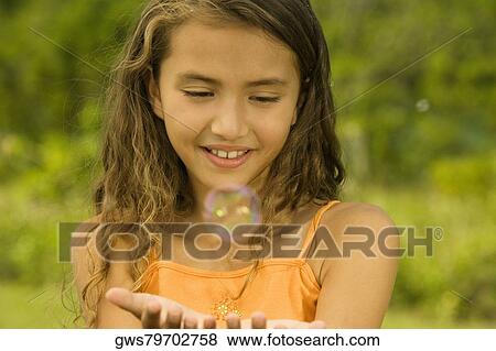 Close-up of a girl catching bubbles View Large Photo Image Stock Photo - Close-up of a girl catching bubbles. Fotosearch