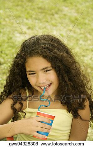 Close-up of a girl holding a disposable cup View Large Photo Image Stock Photo - Close-up of a girl holding a disposable cup. Fotosearch
