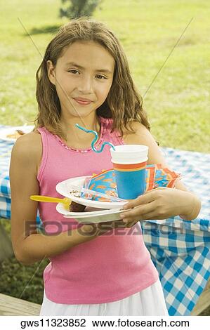 Stock Image - Close-up of a girl holding plates. Fotosearch