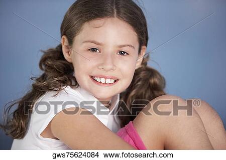 Close-up of a girl hugging her knees View Large Photo Image Picture - Close-up of a girl hugging her knees. Fotosearch