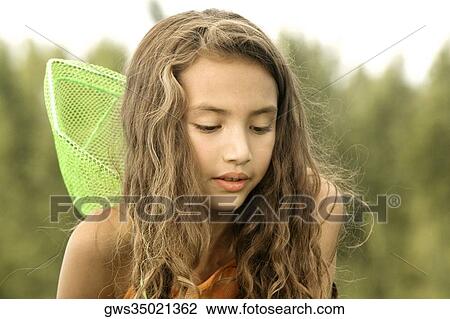 Close-up of a girl looking down View Large Photo Image Stock Image - Close-up of a girl looking down. Fotosearch