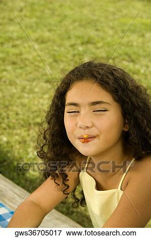 Close-up of a girl with her eyes closed View Large Photo Image Stock Photo - Close-up of a girl with her eyes closed. Fotosearch