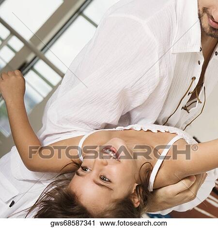 Close-up of a girl with her father View Large Photo Image Stock Image - Close-up of a girl with her father. Fotosearch