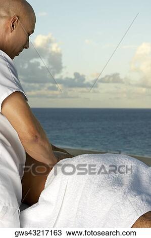Close-up of a man getting a back massage View Large Photo Image Stock Image - Close-up of a man getting a back massage. Fotosearch