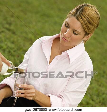 Close-up of a man pouring champagne into a businesswoman's glass View Large Photo Image Stock Image - Close-up of a man pouring champagne into a businesswoman's glass. Fotosearch
