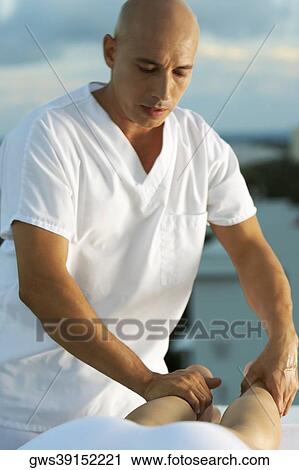 Close-up of a massage therapist massaging a person's leg View Large Photo Image Stock Image - Close-up of a massage therapist massaging a person's leg. Fotosearch