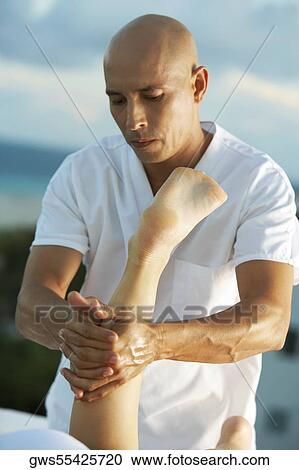 Close-up of a massage therapist massaging a person's leg View Large Photo Image Stock Image - Close-up of a massage therapist massaging a person's leg. Fotosearch
