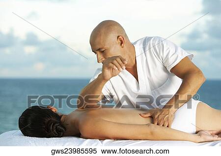 Close-up of a massage therapist massaging a young woman View Large Photo Image Stock Photography - Close-up of a massage therapist massaging a young woman. Fotosearch