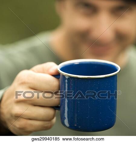 Close-up of a mature man holding a mug View Large Photo Image Stock Photography - Close-up of a mature man holding a mug. Fotosearch