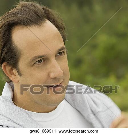 Close-up of a mature man looking away View Large Photo Image Stock Image - Close-up of a mature man looking away. Fotosearch