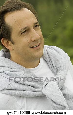 Close-up of a mature man looking away View Large Photo Image Stock Photograph - Close-up of a mature man looking away. Fotosearch