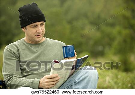Close-up of a mature man reading a magazine View Large Photo Image Stock Image - Close-up of a mature man reading a magazine. Fotosearch
