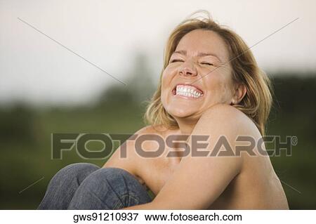 Stock Photo - Close-up of a mature woman clenching her teeth. Fotosearch