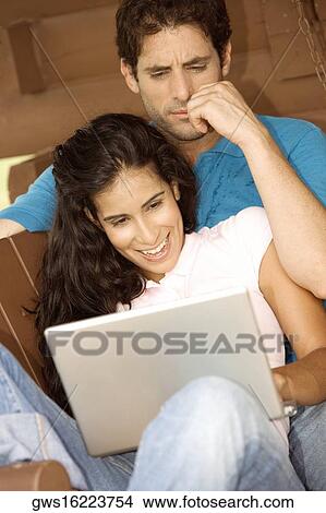 Close-up of a mid adult man and a young woman looking at a laptop View Large Photo Image Picture - Close-up of a mid adult man and a young woman looking at a laptop. Fotosearch