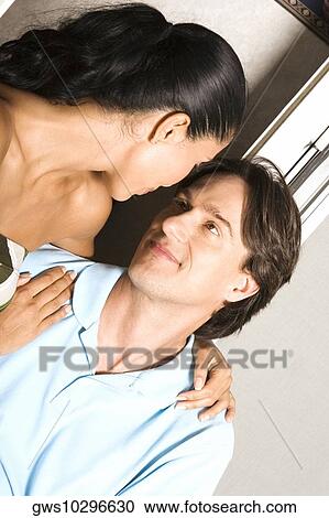 Close-up of a mid adult man and a young woman looking at each other View Large Photo Image Stock Image - Close-up of a mid adult man and a young woman looking at each other. Fotosearch