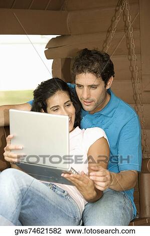 Close-up of a mid adult man and a young woman sitting on the porch View Large Photo Image Stock Image - Close-up of a mid adult man and a young woman sitting on the porch. Fotosearch