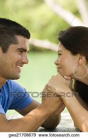 Close-up of a mid adult man and a young woman looking at each other View Large Photo Image Stock Photo - Close-up of a mid adult man and a young woman looking at each other. Fotosearch