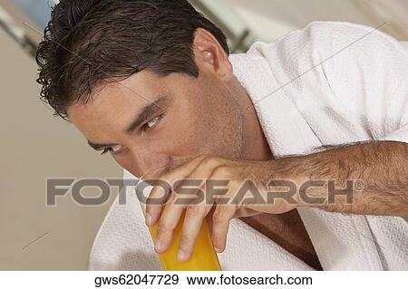 Close-up of a mid adult man drinking a glass of juice View Large Photo Image Stock Photo - Close-up of a mid adult man drinking a glass of juice. Fotosearch