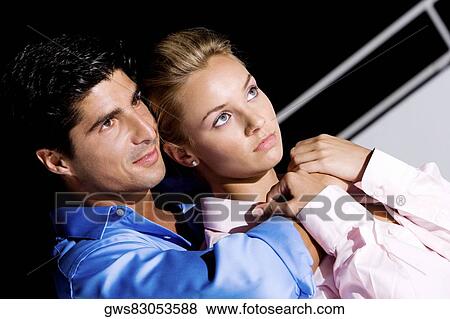 Close-up of a mid adult man embracing a young woman View Large Photo Image Stock Photo - Close-up of a mid adult man embracing a young woman. Fotosearch