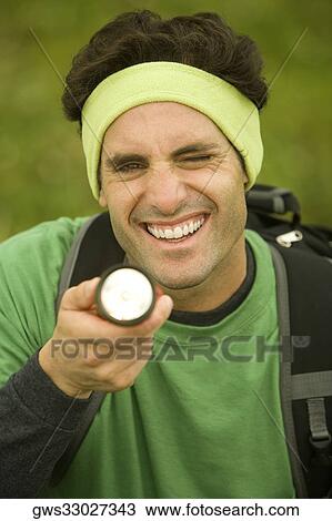 Close-up of a mid adult man holding a flashlight View Large Photo Image Stock Image - Close-up of a mid adult man holding a flashlight. Fotosearch