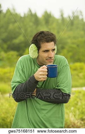 Close-up of a mid adult man holding a coffee cup View Large Photo Image Stock Image - Close-up of a mid adult man holding a coffee cup. Fotosearch