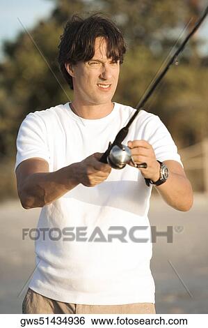 Close-up of a mid adult man holding a fishing rod View Large Photo Image Stock Photograph - Close-up of a mid adult man holding a fishing rod. Fotosearch