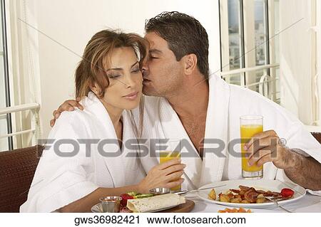 Close-up of a mid adult man kissing a mid adult woman View Large Photo Image Stock Image - Close-up of a mid adult man kissing a mid adult woman. Fotosearch
