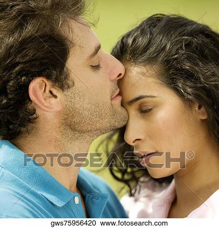 Close-up of a mid adult man kissing a young woman View Large Photo Image Stock Image - Close-up of a mid adult man kissing a young woman. Fotosearch