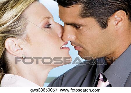 Close-up of a mid adult man kissing a young woman View Large Photo Image Stock Photo - Close-up of a mid adult man kissing a young woman. Fotosearch