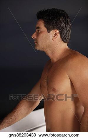 Stock Image - Close-up of a mid adult man looking away. Fotosearch