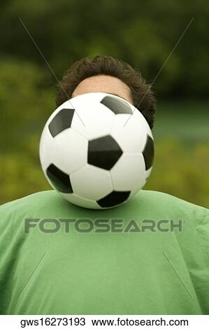 Close-up of a mid adult man playing with a soccer ball View Large Photo Image Stock Image - Close-up of a mid adult man playing with a soccer ball. Fotosearch