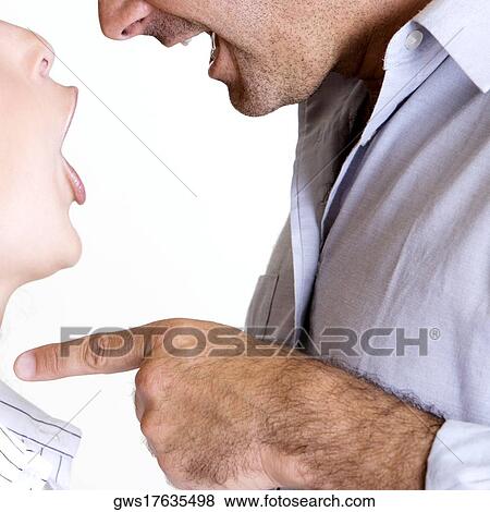 Close-up of a mid adult man shouting at a young woman View Large Photo Image Stock Photo - Close-up of a mid adult man shouting at a young woman. Fotosearch