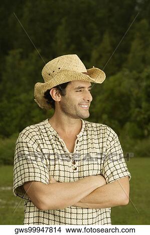 Picture - Close-up of a mid adult man standing with his arms crossed. Fotosearch