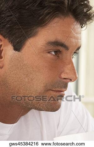 Close-up of a mid adult man thinking View Large Photo Image Stock Photograph - Close-up of a mid adult man thinking. Fotosearch