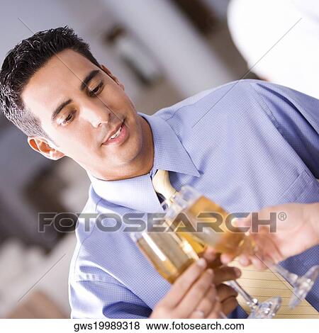 Close-up of a mid adult man toasting View Large Photo Image Stock Photo - Close-up of a mid adult man toasting. Fotosearch