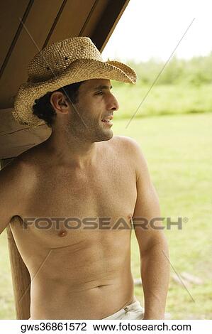 Close-up of a mid adult man wearing a hat View Large Photo Image Stock Image - Close-up of a mid adult man wearing a hat. Fotosearch