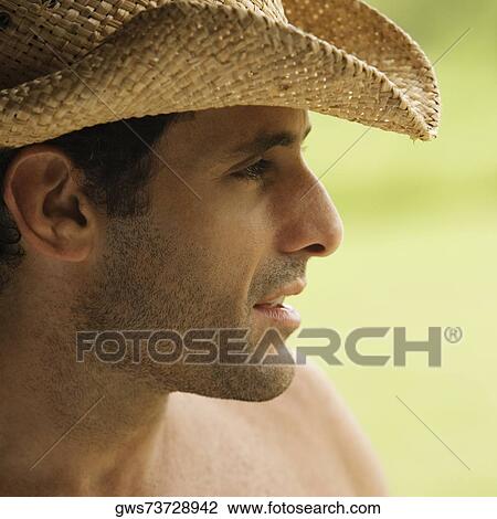 Close-up of a mid adult man wearing a hat View Large Photo Image Stock Image - Close-up of a mid adult man wearing a hat. Fotosearch