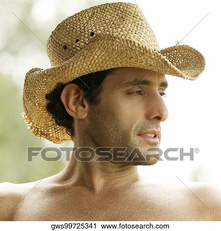 Close-up of a mid adult man wearing a cowboy hat View Large Photo Image Stock Image - Close-up of a mid adult man wearing a cowboy hat. Fotosearch
