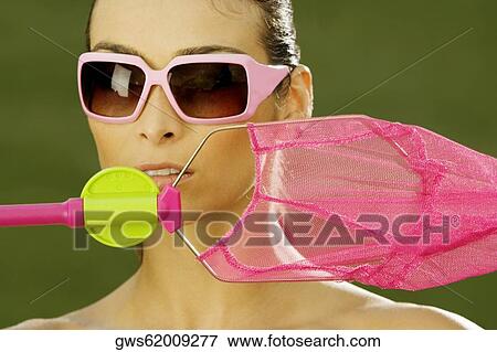 Close-up of a mid adult woman holding a butterfly net View Large Photo Image Stock Photo - Close-up of a mid adult woman holding a butterfly net. Fotosearch