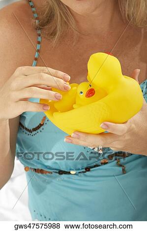Close-up of a mid adult woman holding rubber ducks View Large Photo Image Stock Photo - Close-up of a mid adult woman holding rubber ducks. Fotosearch