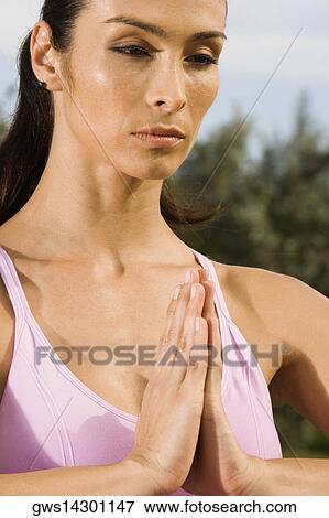Stock Photo - Close-up of a mid adult woman in a prayer position. Fotosearch