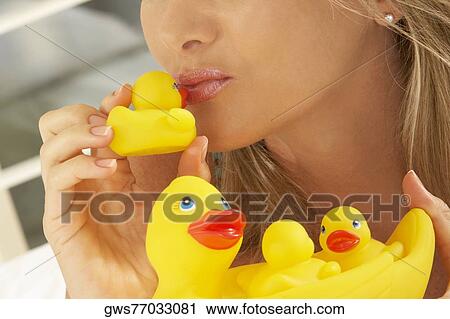Close-up of a mid adult woman kissing a rubber duck View Large Photo Image Stock Image - Close-up of a mid adult woman kissing a rubber duck. Fotosearch