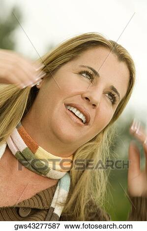 Close-up of a mid adult woman looking away View Large Photo Image Stock Photo - Close-up of a mid adult woman looking away. Fotosearch